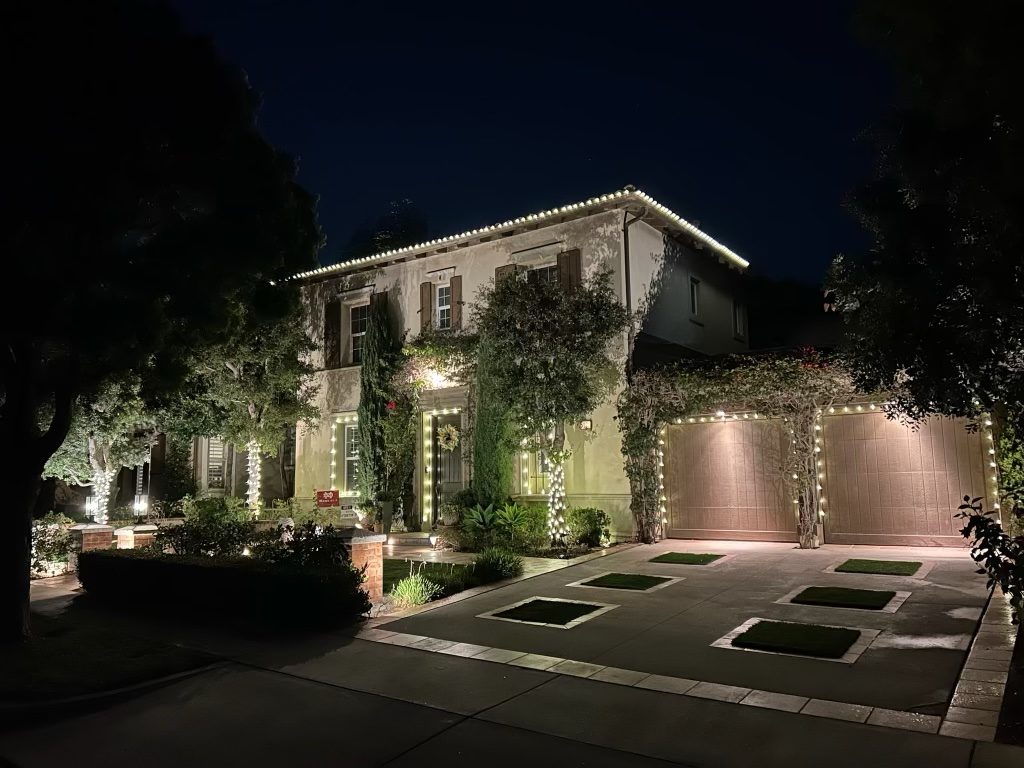Two-story home with roofline and garage holiday lighting