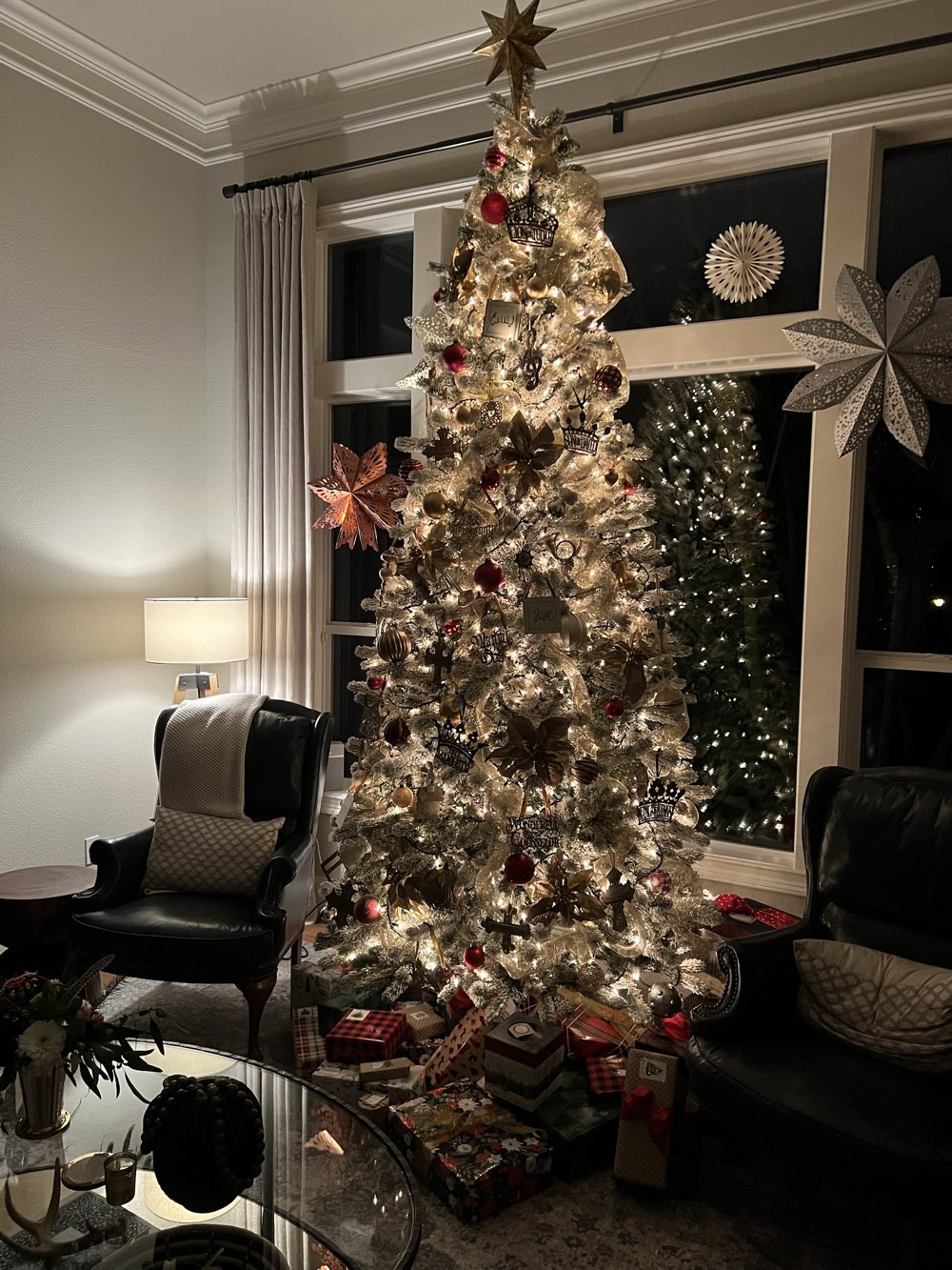 Fully decorated indoor Christmas tree with gold and red ornaments